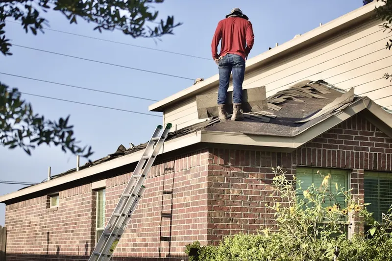 Professional roofer working on a residential roof in Holtzinger